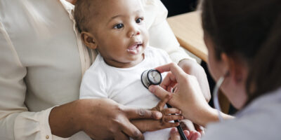 A doctor provides care to a baby.