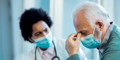 Man with sinus pain at the doctor.